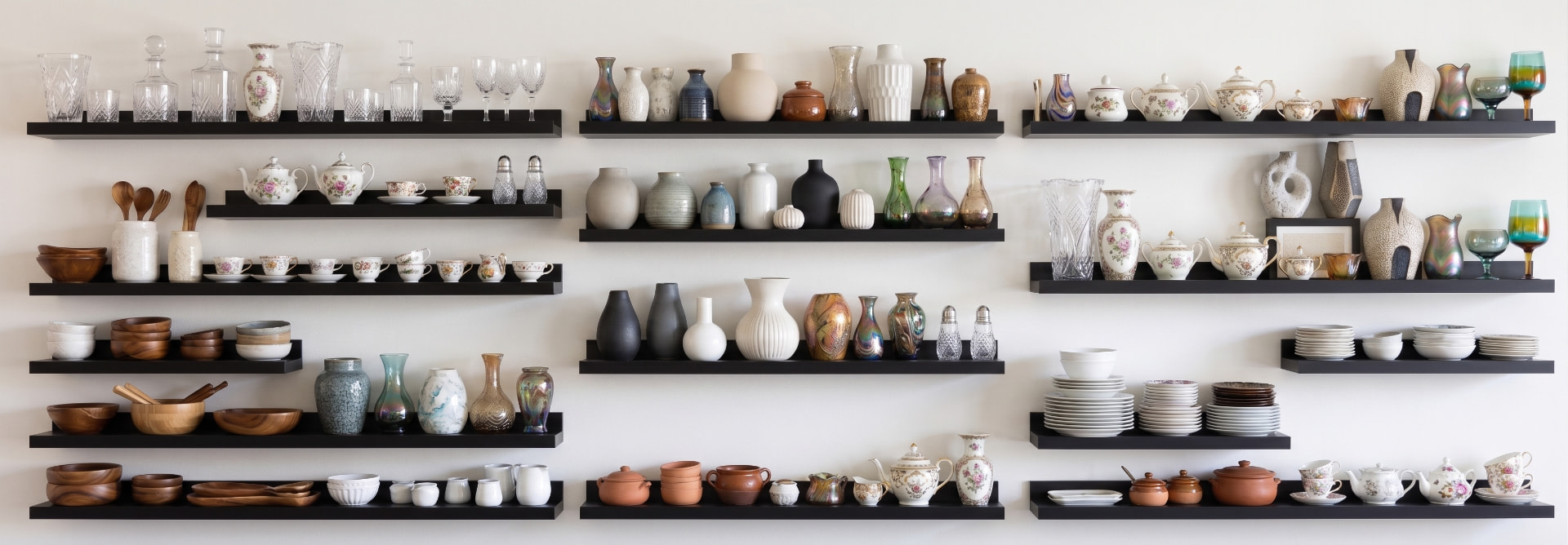 A wide collection of crystal, ceramics, china and art glass displayed on shelves
